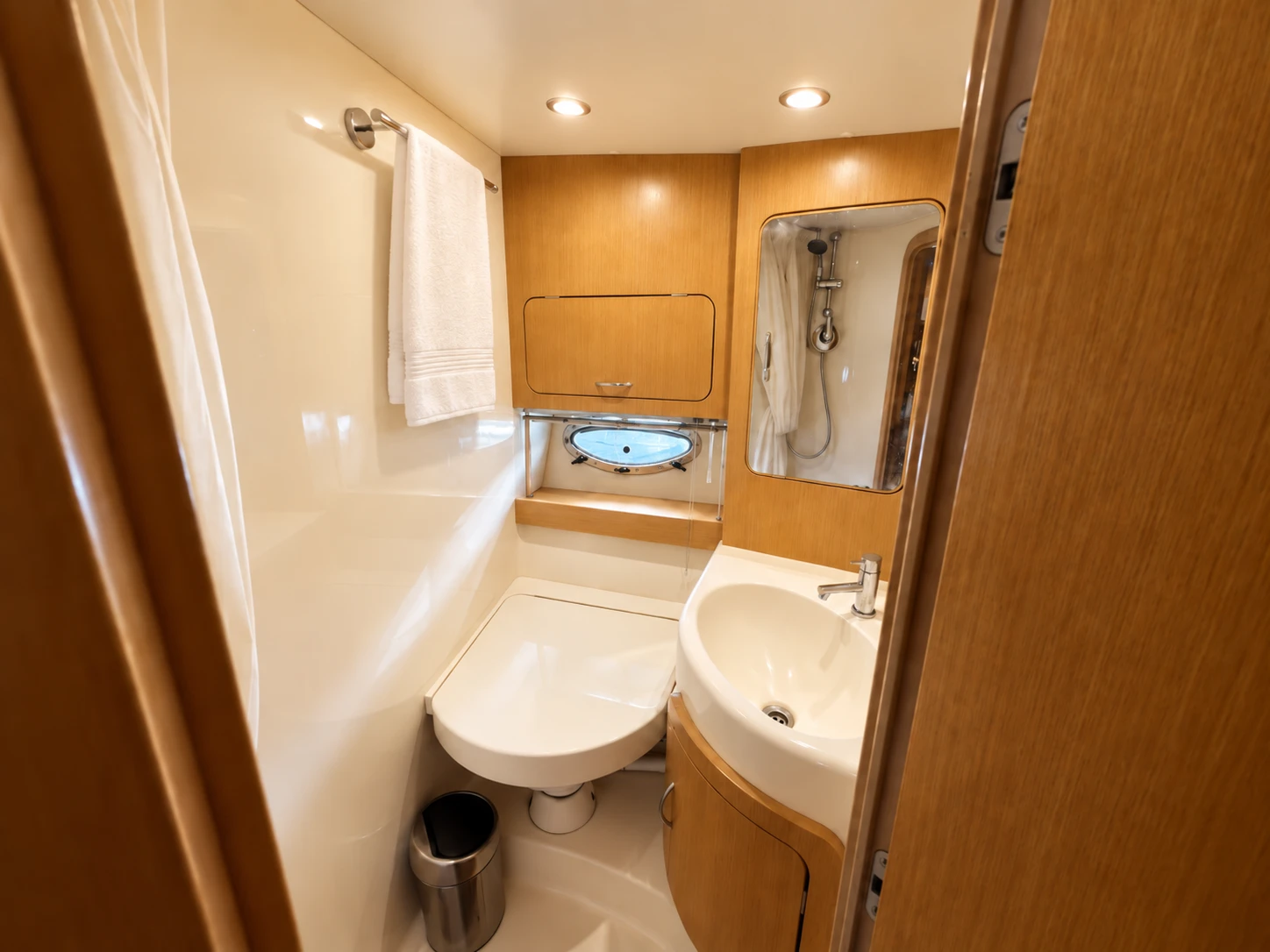 On-board bathroom with shower, fresh towels and teak cabinets